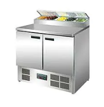 stainless steel prep counter with colourful foods in containers on top