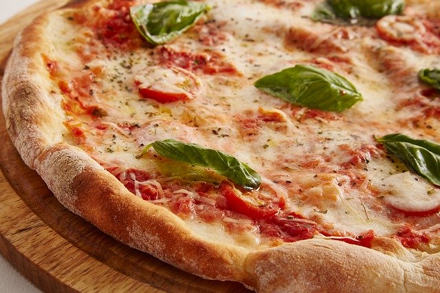 Close up of pizza on wooden board