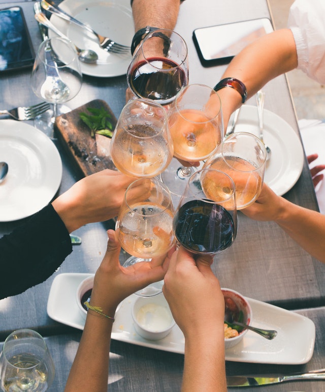 People toasting with wine glasses