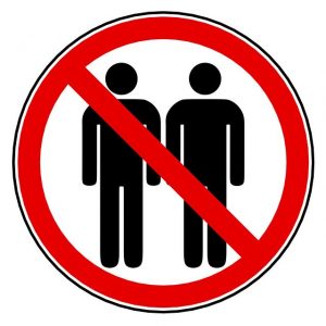 Warning sign with people standing close together with red line through