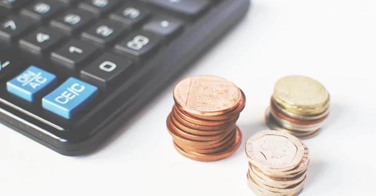 calculator and piles of coins