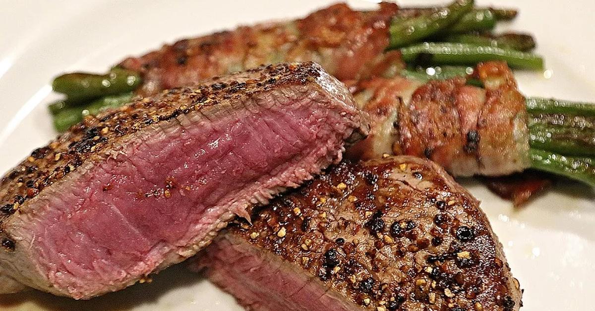 cooked steak on plate with asparagus