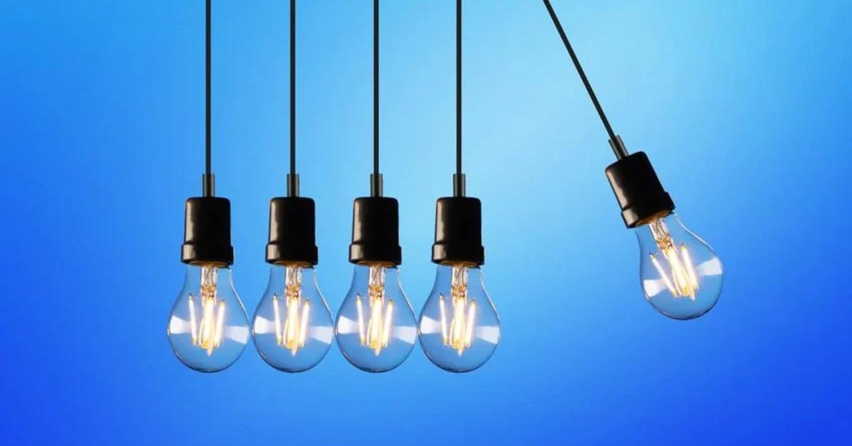 five lightbulbs hanging side by side on blue background